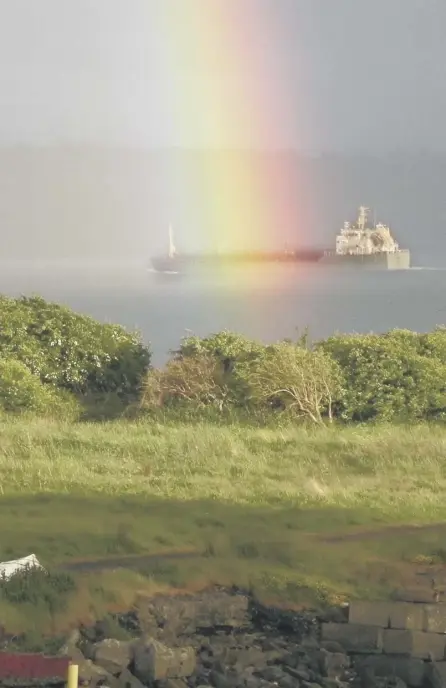  ??  ?? 2A watergaw – or rainbow – seems to bathe a ship in the Firth of Forth in its brightly coloured lights