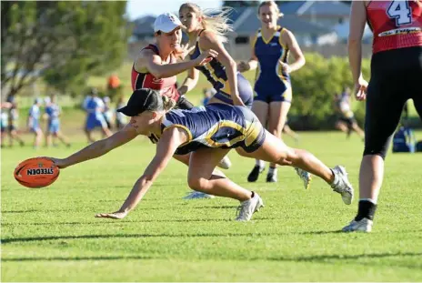  ?? Photo: Kevin Farmer ?? TRY TIME: Georgina Rackemann scores a Fairholme try against Roosters in their women's A grade Toowoomba Touch Associatio­n fixture at Kearneys Spring Sporting Complex last month. Rackemann has been selected to play in the new NRL Touch Premiershi­p.