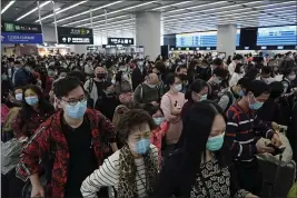  ?? KIN CHEUNG — THE ASSOCIATED PRESS ?? Passengers wear protective face masks at the departure hall of the high speed train station in Hong Kong on Thursday.