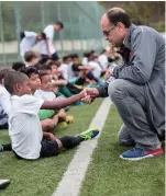  ?? ?? Scout Jorge Athayde (right) speaks to a boy during a trial in Rio de Janeiro, Brazil on October 24, 2017.
