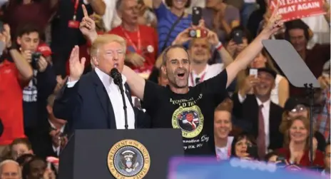  ?? JOE RAEDLE/GETTY IMAGES ?? U.S. President Donald Trump pulled supporter Gene Huber on stage during a raucous campaign rally at Orlando Melbourne Internatio­nal Airport.