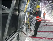  ??  ?? Tomi Kurtakko installs a giant triangle-shaped plastic mould that will be filled with compacted snow to form the walls for an igloo entrance. Each dome has 10-foot-thick ceilings and walls “as solid as concrete.” To start, a giant igloo-shaped balloon...