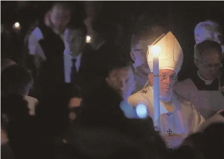  ?? AP PHOTO ?? SOLEMN CEREMONY: Pope Francis celebrates the Easter vigil at St. Peter’s Basilica at the Vatican Saturday night. The pope called for peace in his formal Easter message.