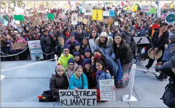  ??  ?? Thunberg takes a photo with local activists during a climate strike march at the Alberta Legislatur­e in Edmonton, Alberta, Canada. — Reuters photo