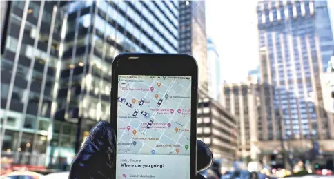  ??  ?? An iPhone with the Lyft ride-sharing app on it shows cars in the area on Park Avenue in New York City. — AFP photo