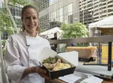  ??  ?? Raclette Suisse chef Carolina D. Acecis displays a raclette, melted cheese over fried potatoes, available at this year’s Front Street Foods market.