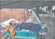  ?? ?? (Above) An earthquake survivor lies on a gurney at a makeshift hospital, where the wounded are being treated in the yard (centre). Meanwhile, rescuers (right) remove the wreckages of vehicles damaged in the earthquake-triggered landslide in Cianjur, West Java.