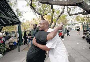  ?? Photograph­s by Francine Orr Los Angeles Times ?? ADVOCATES FOR a separate skid row neighborho­od council alleged last month’s election was corrupted by improper campaignin­g. Above, Cocoa Sherry Write, left, and Twin Skid Row hug on the day of the vote.