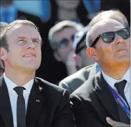  ?? Michel Euler ?? The Associated Press French President Emmanuel Macron and Dassault Aviation CEO Eric Trappier, right, watch demonstrat­ion flights Monday as part of the Paris Air Show in Le Bourget, France.
