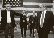  ??  ?? Honeywell vice president Tony Stallings appears to offer a mask to Trump during the tour.