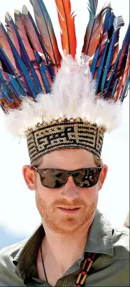  ??  ?? HEAD MAN: Harry was ‘crowned’ with a traditiona­l headdress in Guyana in the Caribbean yesterday