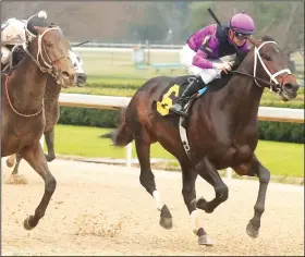  ?? (The Sentinel-Record/Richard Rasmussen) ?? Jockey Florent Geroux and Warrior’s Charge (6) outlasts Jockey Ricardo Santana Jr., and Bankit (left) to win the Razorback Handicap at Oaklawn Racing Casino Resort Monday.