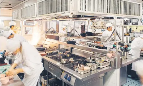  ??  ?? Inside the kitchen at Nahm restaurant in Bangkok.