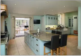  ??  ?? The spacious pastel coloured breakfasti­ng kitchen leads through to the orangery