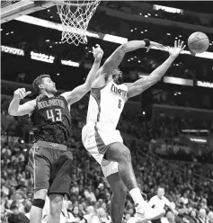  ??  ?? Kris Humphries (left) of the Atlanta Hawks battles DeAndre Jordan of the Los Angeles Clippers for a rebound during the second half of the game at Staples Centre in Los Angeles, California. — AFP photo