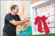  ??  ?? Derrick Brown, founder of the Write Bloody publishing house, cuts the ribbon Sunday on his bricks-and-mortar store in East Austin.