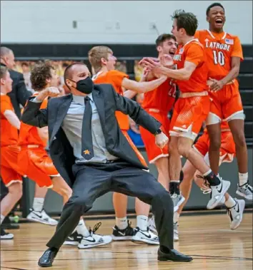  ?? Steve Mellon/Post-Gazette ?? Latrobe assistant coach Ryan Yarosik and Wildcats players celebrate a 61-59 victory against Thomas Jefferson in a WPIAL Class 5A game.