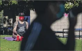  ?? Jason Armond Los Angeles Times ?? ANTHONY CHERRO of Los Angeles relaxes at La Cienega Park. Many residents who have strictly followed stay-at-home orders have reached a breaking point.