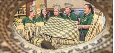  ??  ?? Traditiona­l appeal: Weavers from the Kuba’an-Puak FMU showing a variety of rattan handicraft during the workshop in Kuching.