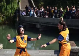  ??  ?? Artists perform during the 7th annual Wuzhen Theatre Festival.— AFP photos