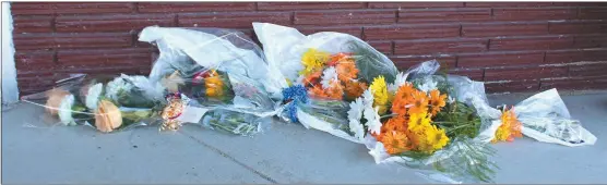  ?? Mona Weatherly ?? Shown above, flowers are left in memory of Cris Esch in front of her business, Costa’s, on the west side of the Square on Monday, July 13. Esch died Saturday, July 11 after being shot.