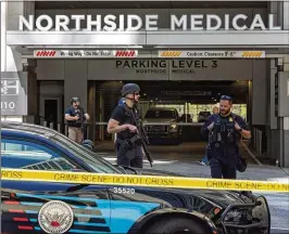  ?? ARVIN TEMKAR/ARVIN.TEMKAR@AJC.COM ?? Officers are deployed on West Peachtree Street at the Northside Hospital Midtown medical office building where five people were shot in May. Incidents like this are leading to proposals to increase safety in public places.