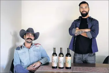  ?? AP PHOTO ?? Alex Howe (right) and Chip Forsythe, cofounders of Rebel Coast, pose for photos with their cannabis-infused wine in Los Angeles.