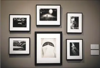  ??  ?? FINE ART photograph­s by a variety of artists decorate a wall at John Wells Production­s.