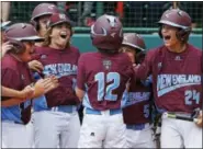  ?? GENE J. PUSKAR — THE ASSOCIATED PRESS ?? Fairfield American’s Troy Ashkinos (12) is greeted by teammates after hitting a grand slam in the fourth inning on Wednesday.