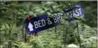  ??  ?? A sign in the Allegheny National Forest that directs hikers to Peggy and Ken Butler’s Black Caddis Ranch in Kelletvill­e, Pa.