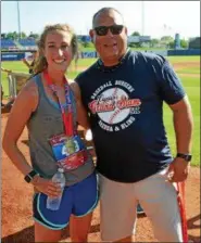  ?? PAUL DICICCO — THE NEWS-HERALD ?? Women’s winner, Justinine Dams poses with Carlos Baerga July 7 at the Captains Charities 5K road race.