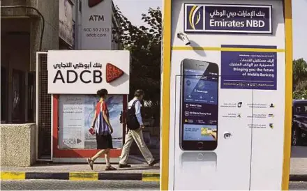  ?? BLOOMBERG PIC ?? Three of Abu Dhabi’s state-linked banks are in talks to combine into an institutio­n with US$110 billion of assets, according to Abu Dhabi Commercial Bank PJSC.