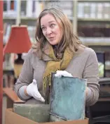  ??  ?? PAT MCDONOGH/CJ Sarah Lindgren of Louisville Metro Archives opens a box that was under a Confederat­e monument.