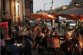  ?? Photograph: Scott Heins/The Guardian ?? People eating dinner at the Row Harlem on Friday night, where business has been booming over the summer.