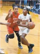  ?? AMY DAVIS/BALTIMORE SUN ?? Roland Park’s Rain Green defends against the drive of McDonogh’s Jayla Oden during the Reds’ victory over the host Eagles in an IAAM A Conference matchup.
