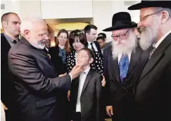  ??  ?? Prime Minister Narendra Modi meets 11-year-old Moshe Holtzberg, one of the survivors of the 26/11 Mumbai terror attacks, in Israel on Wednesday