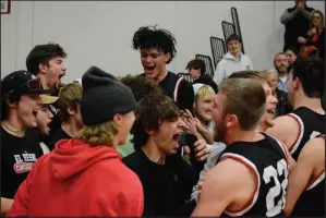  ?? Bennett Horne/McDonald County Press ?? (Above photo) Joshua Pacheco (back, center) and Weston Gordon (22) celebrate winning the Big 8 West crown with members of the MCHS student body at Nevada on Friday, Feb. 10. (Top photo) The McDonald County Mustangs defeated the Nevada Tigers, 60-57 to claim the Big 8 West title for the second season in a row.