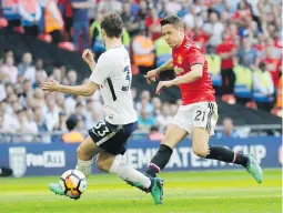  ?? THE ASSOCIATED PRESS ?? Manchester United’s Ander Herrera scores his team’s second goal past Tottenham's Ben Davies, left, in Saturday’s FA Cup semifinal.