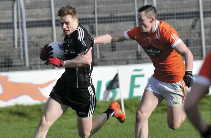  ??  ?? Sligo’s Kevin McDonnell eludes the challenge of Aaron McKay of Armagh during their Allianz League Division 3 encounter in Markievicz Park on Sunday. The game ended in a draw. Pic: Carl Brennan.