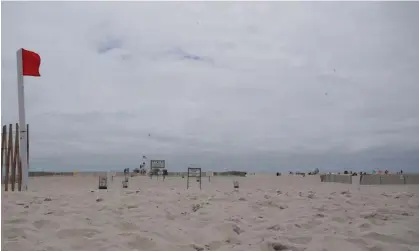  ?? Photograph: Bryan R Smith/AFP/Getty
Images ?? An empty Jones Beach on Long Island, New York, in 2020. A 37-year-old swimmer off Jones Beach was in the water Thursday when he ‘sustained a laceration to his right foot’ that officials reportedly described as a possible shark bite.