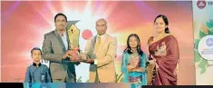  ??  ?? Best Dealer 2013 Award being presented to City Hardware Jaffna by Gnanam