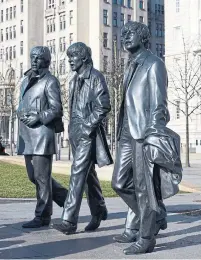  ??  ?? Statues of the Beatles loom on Liverpool’s waterfront.