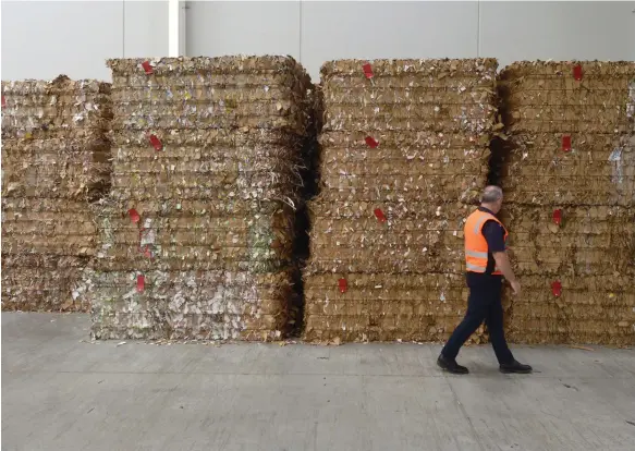  ?? Bloomberg; Getty Images ?? Clockwise from above, bales of waste cardboard ready for recycling in Melbourne, south-east Australia; products such as detergents are easier to package in plastic; paper coffee cups often have some form of plastic liner, hampering recycling efforts after they are discarded