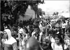  ??  ?? Honduran migrants, part of a caravan trying to reach the U.S., walk during a new leg of their travel in Chiquimula, Guatemala. (Photo: Reuters)