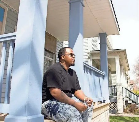  ?? REBECCA CARBALLO / MILWAUKEE JOURNAL SENTINEL ?? Theodore Miles sits on the front steps of his future home that he built with Habitat for Humanity.