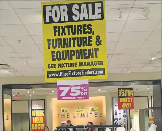  ?? [BARBARA PERENIC/DISPATCH] ?? Liquidator­s sell off stores’ remaining stock as well as furniture and other equipment.