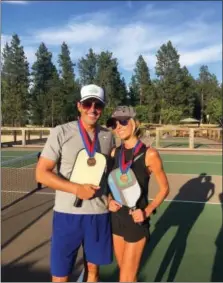  ?? GIULIANA RANCIC VIA AP ?? Bill and Giuliana Rancic pose for a photo in Harrison, Idaho after winning a Mixed Doubles Pickleball Tournament. It’s tempting to blow off a workout, but getting sweaty with your significan­t other makes a workout more fun and ups the intensity ante.