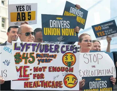  ?? RICH PEDRONCELL­I THE ASSOCIATED PRESS ?? Dozens of supporters of a measure to limit when companies can label workers as independen­t contractor­s rally in Sacramento, Calif. Uber, Lyft and DoorDash have collective­ly contribute­d $90 million toward an initiative that would exempt them from the law.