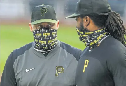  ?? ASSOCIATED PRESS FILE PHOTOS ?? Pittsburgh Pirates first baseman Josh Bell, right, listens to manager Derek Shelton during a July 7 team workout at PNC Park in Pittsburgh. Shelton and other first-year managers are scrambling to make up for lost time. The rookie skippers are getting creative when it comes to getting a feel for their players during a season unlike any other.