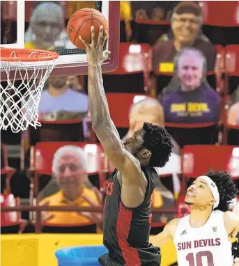  ?? ROSS D. FRANKLIN AP ?? SDSU’s Nathan Mensah dunks for two of his 17 points Thursday as ASU’s Jaelen House can only watch.